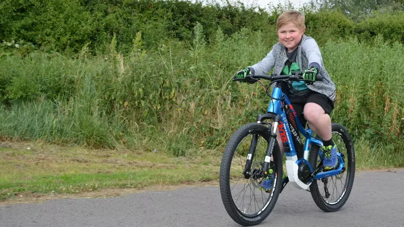 Physically challenged Kid riding an e-bike